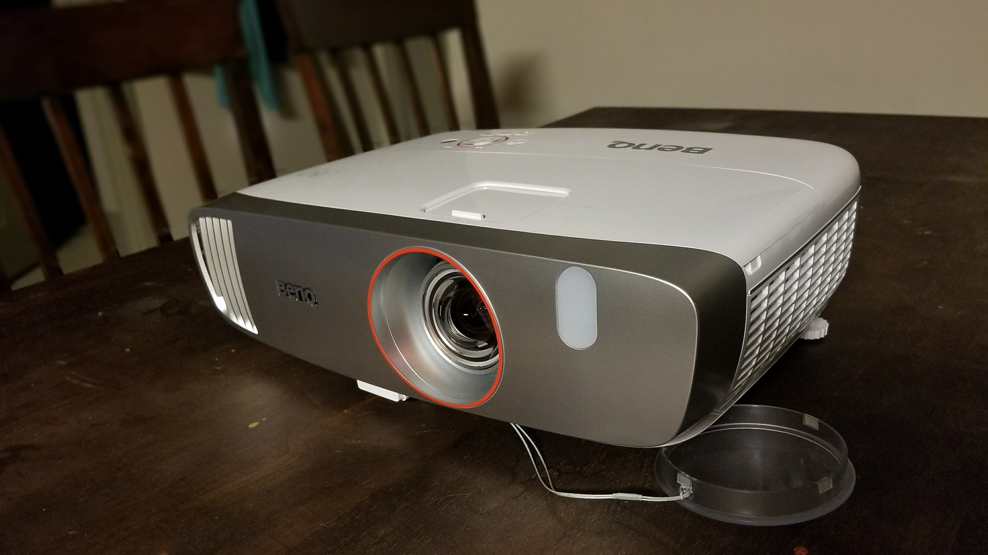 Silver projector on wooden surface