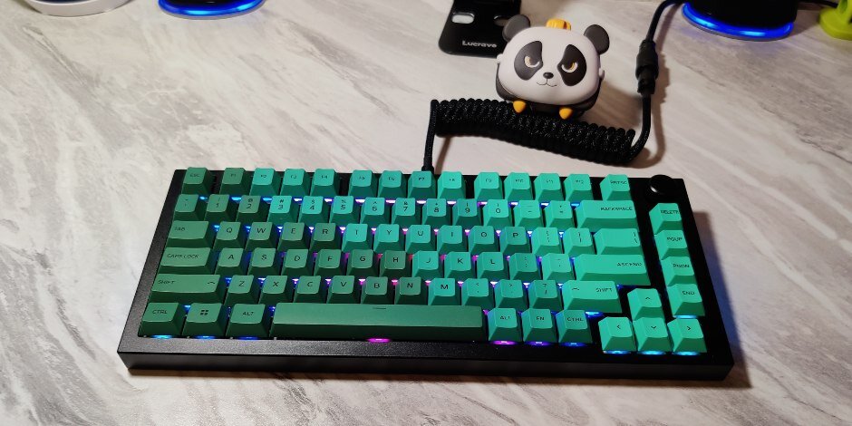 White keyboard with panda plushie