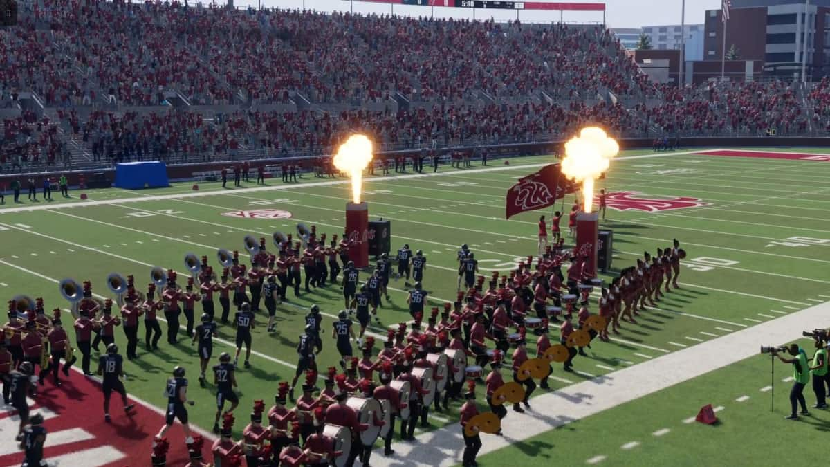 Spectators watch collegiate football team march