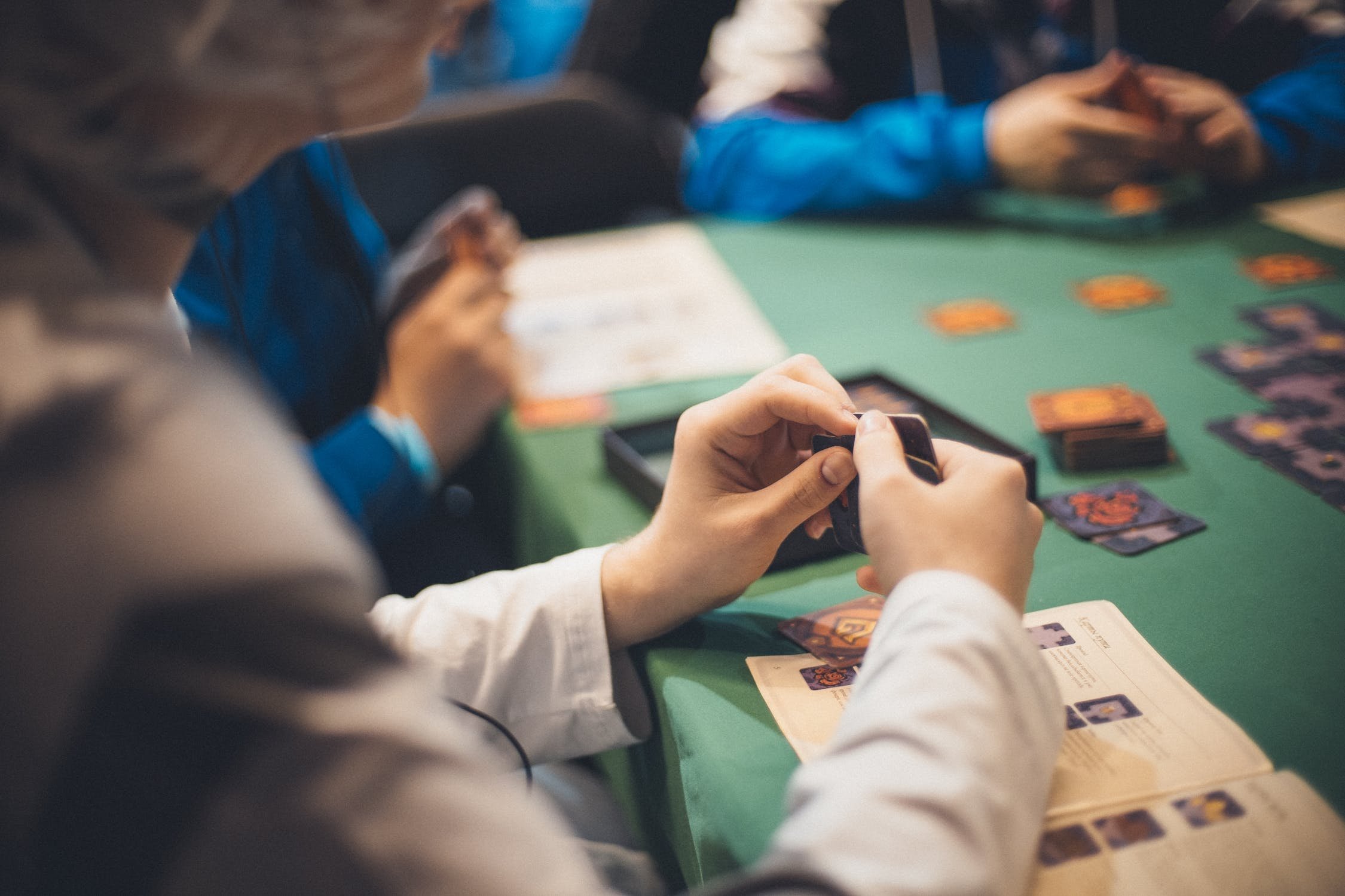 People playing cards at table