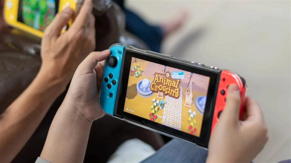 Hands holding Nintendo Switch gaming console