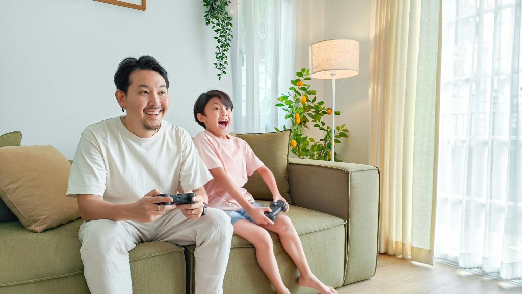 Two gamers playing together on couch