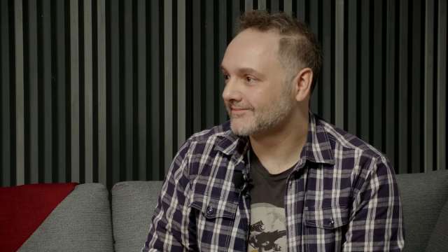 Smiling man in plaid shirt