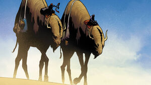 Two beasts crossing desert landscape