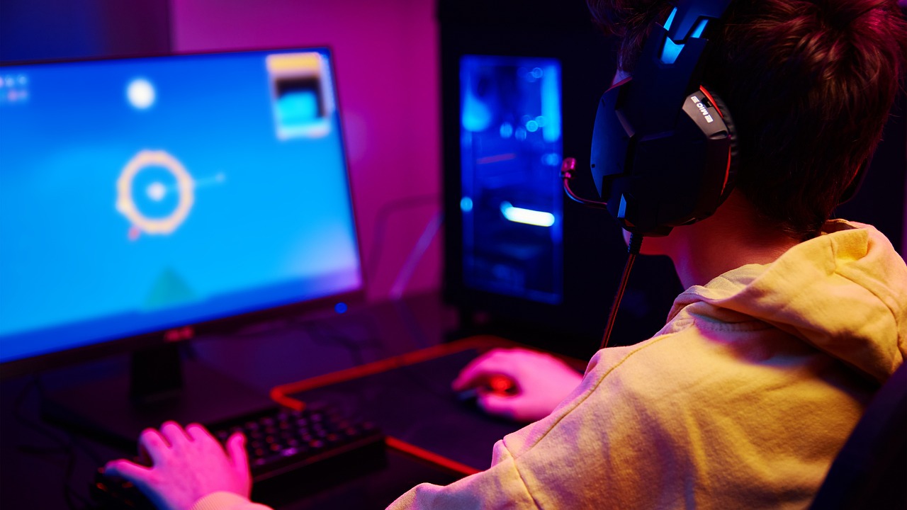 Gamer playing at computer desk