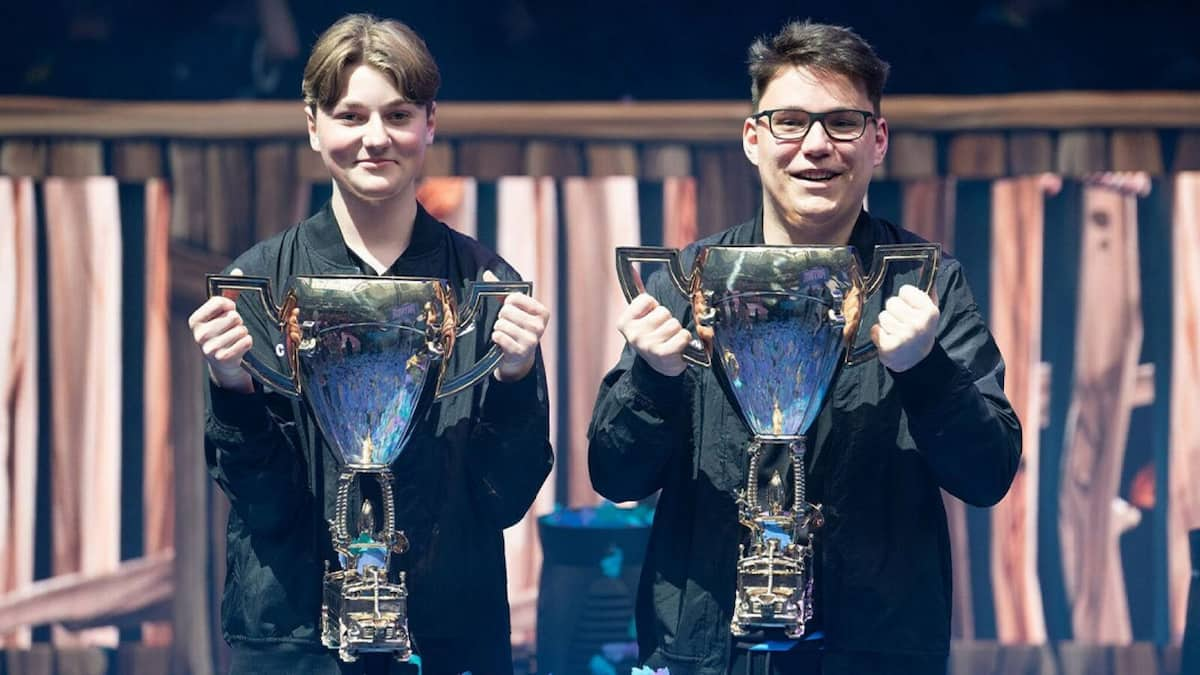 Two gamers with Fortnite championship trophies