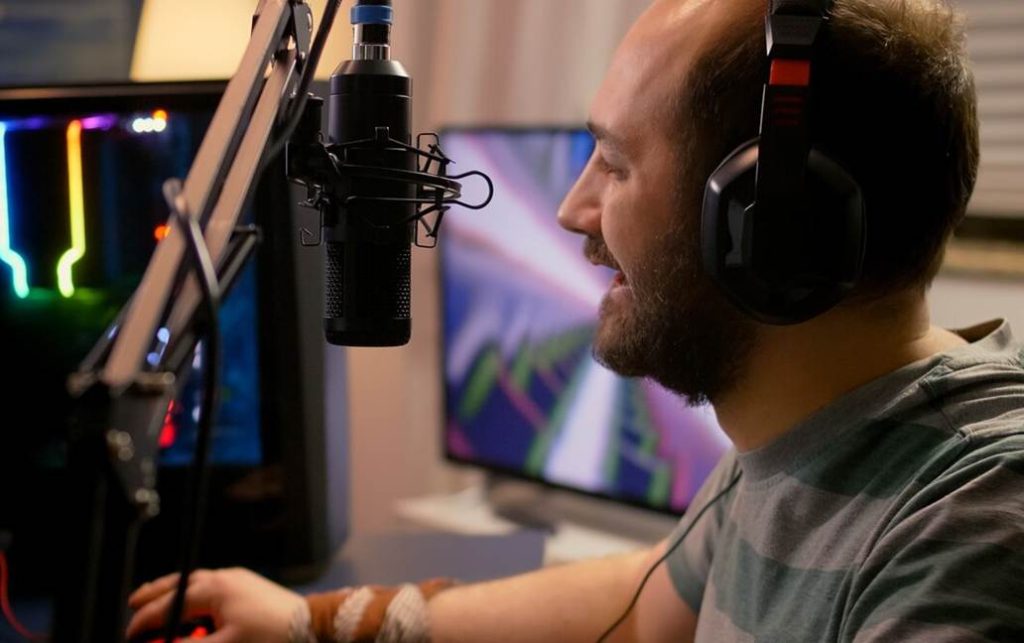 Gamer wearing headphones playing videogame