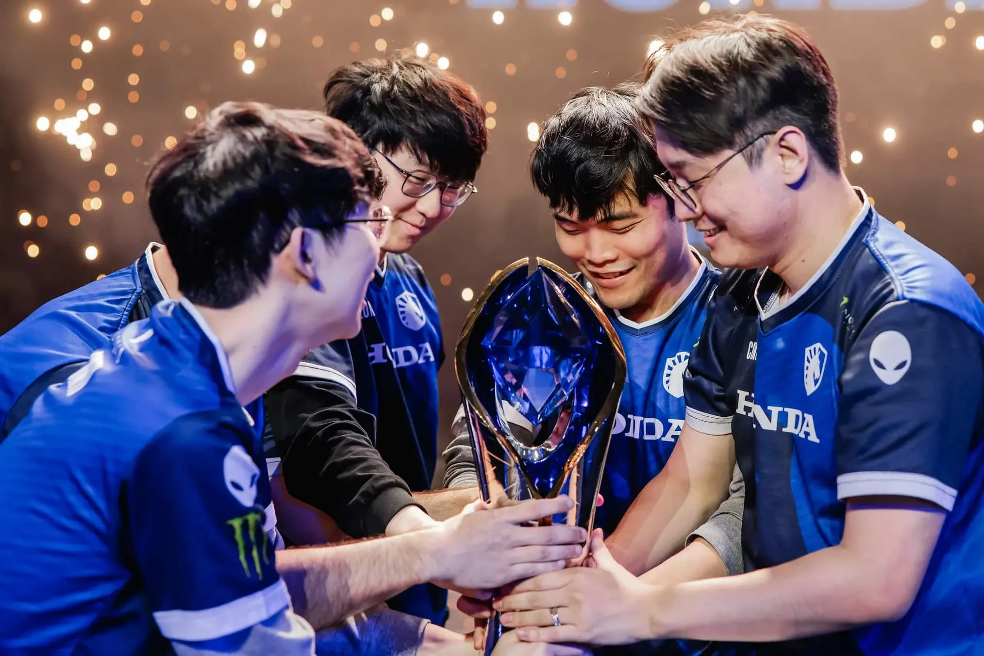 Esports team hoisting victory trophy