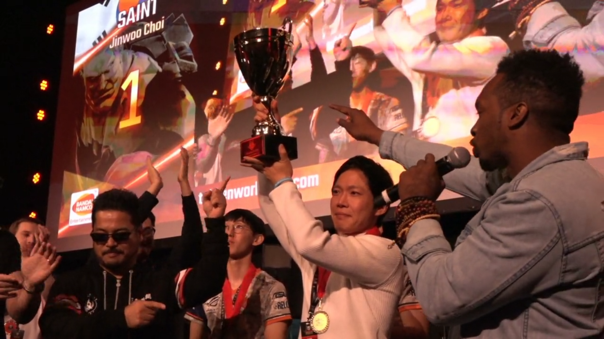 Smiling esports player holds gaming trophy